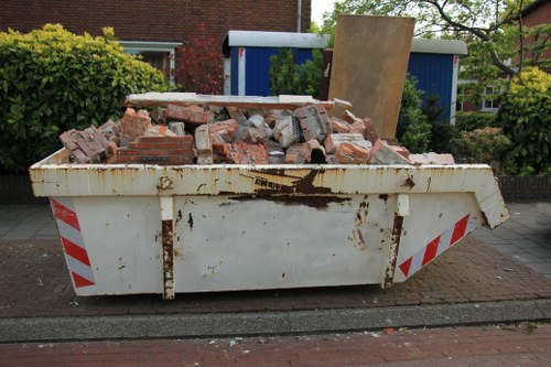 Professionals removing a sofa in a West Hampstead home